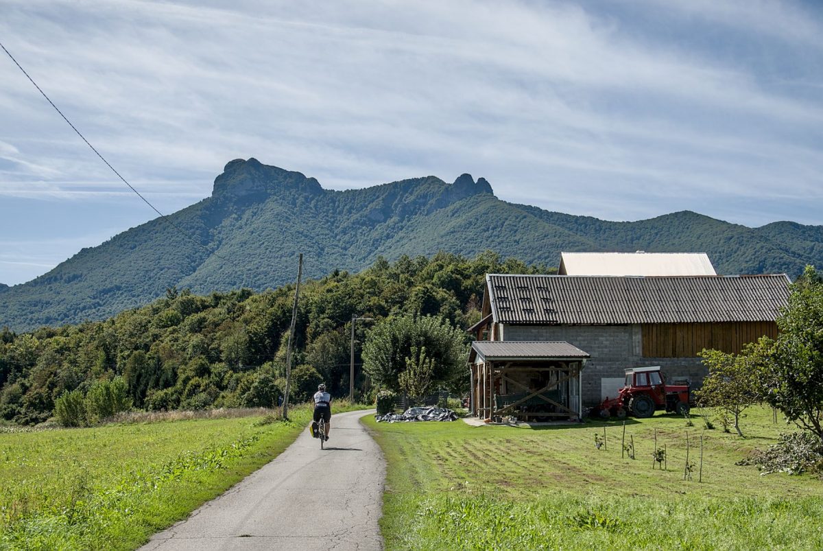 Cycling through the village of Brestovac Ogulinski. The peak of Klek dominates the sky above us.