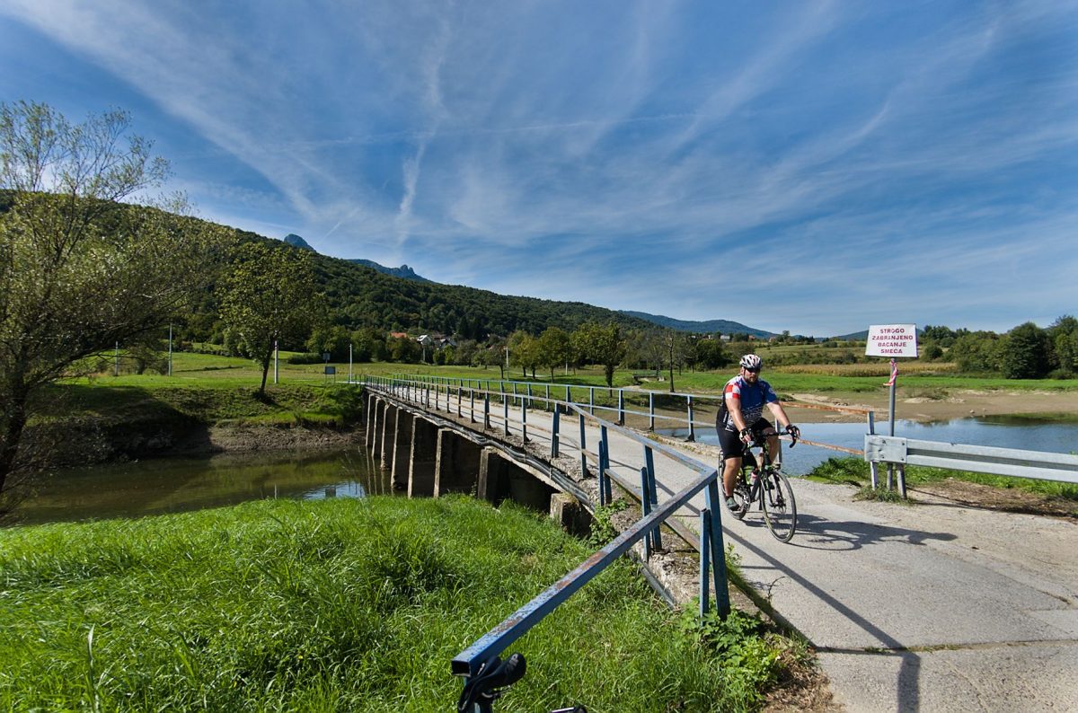 The bridge over the Dobra River at the entrance to Ogulin. The peak of Klek is visible from the hill.